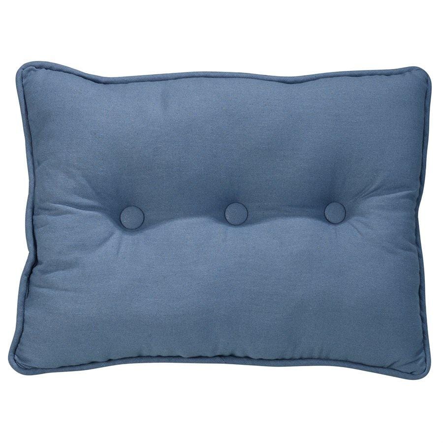 WHite and blue pillows accent a white linen couch placed in a